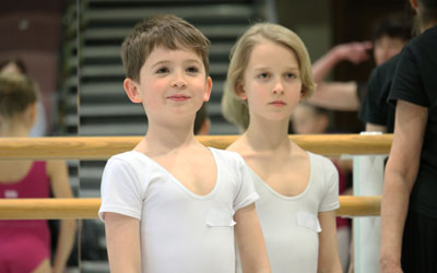 Online Junior Associate Insight Day Two young boys smiling in a Junior Associate Insight Day ballet class