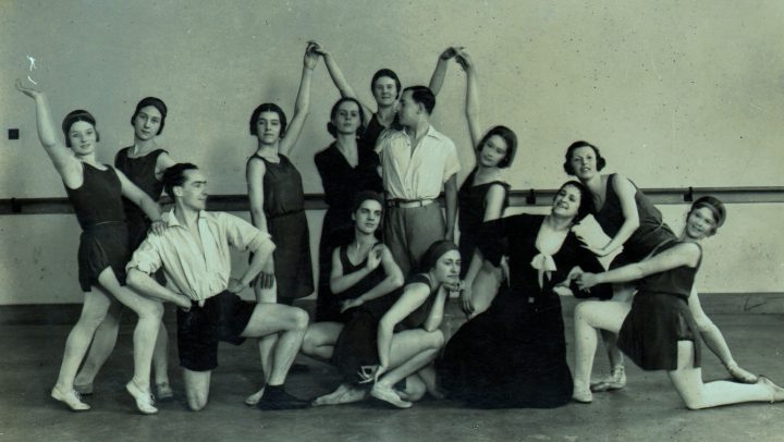Ninette de Valois (standing centre) and Ursula Moreton (kneeling in dress) with students of the Vic-Wells School just after it became resident at Sadler’s Wells Theatre in 1931.